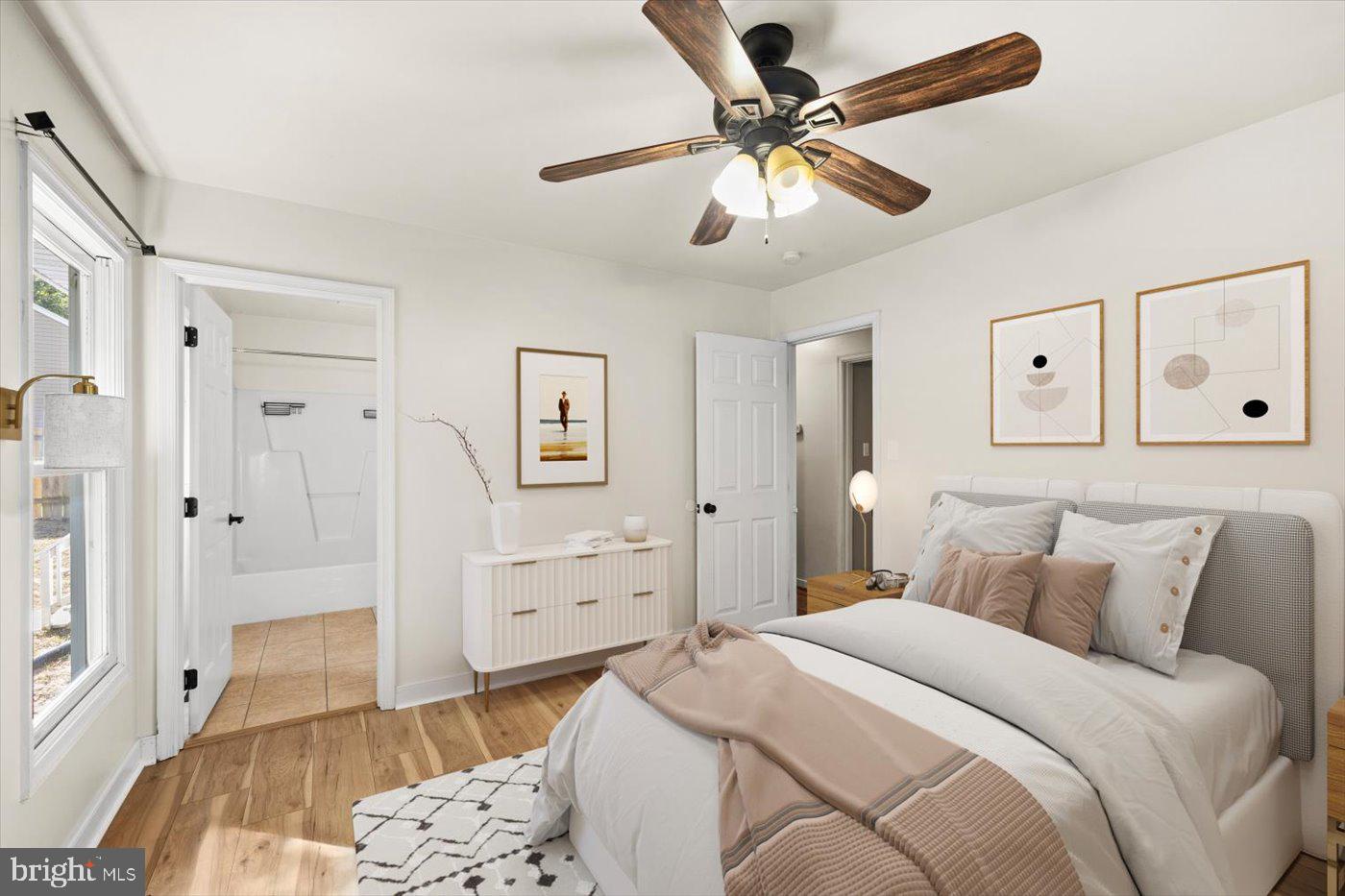 975 Swan Lane Ruther Glen, VA 22546 - Photo 21 of 42 a bedroom with a bed and a chandelier