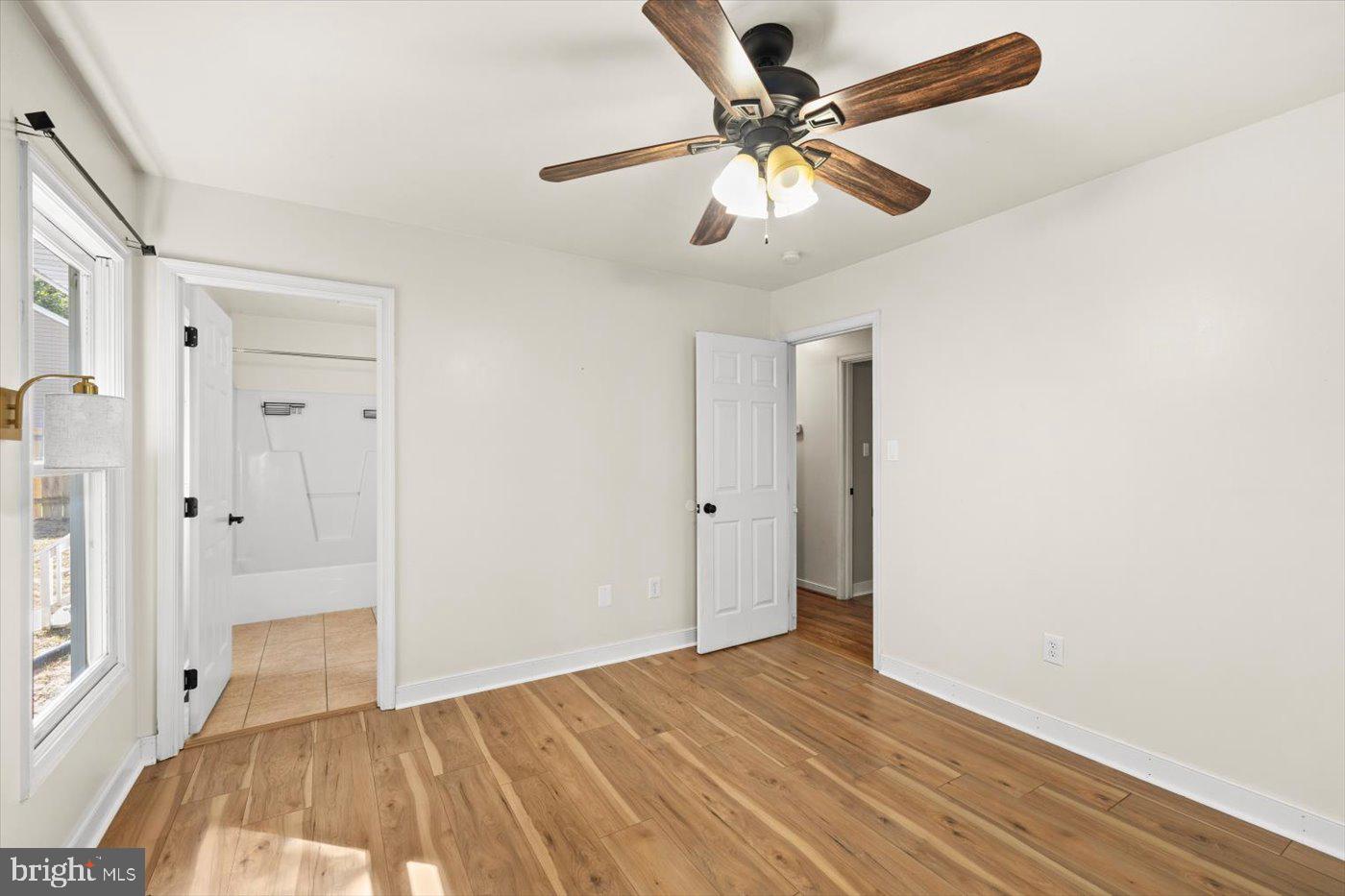 975 Swan Lane Ruther Glen, VA 22546 - Photo 22 of 42 an empty room with wooden floor and ceiling fan