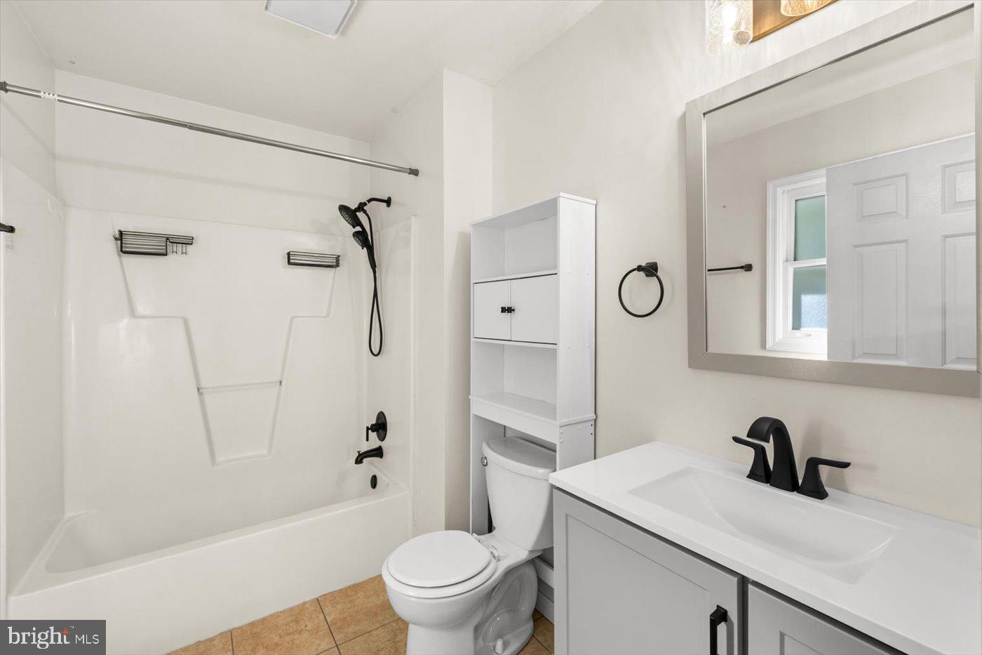 975 Swan Lane Ruther Glen, VA 22546 - Photo 23 of 42 a bathroom with a granite countertop sink toilet a mirror and shower