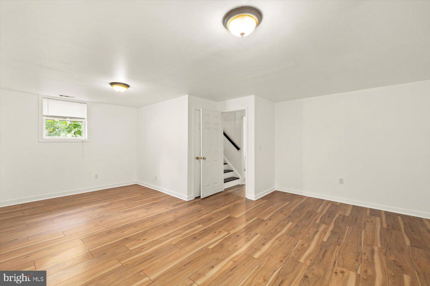 975 Swan Lane Ruther Glen, VA 22546 - Photo 25 of 42 an empty room with wooden floor and windows