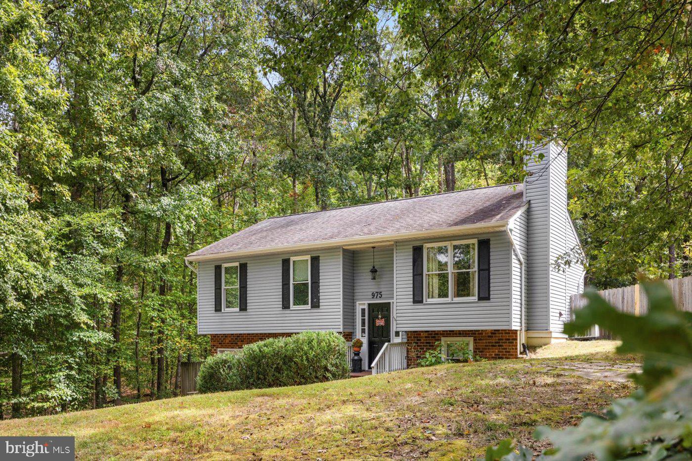 975 Swan Lane Ruther Glen, VA 22546 - Photo 3 of 42 a front view of a house with a yard