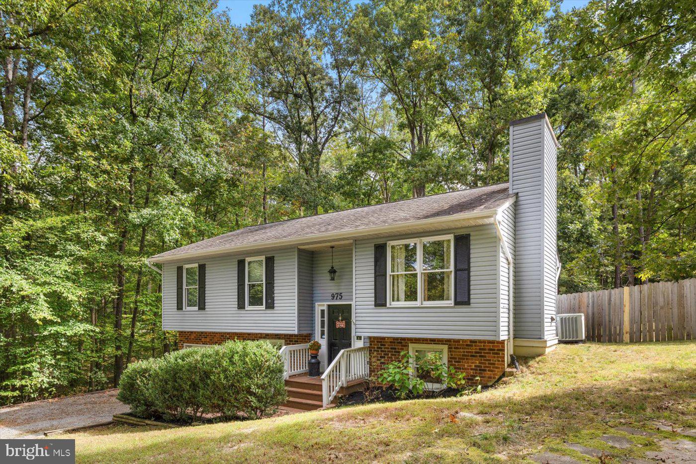 975 Swan Lane Ruther Glen, VA 22546 - Photo 4 of 42 a front view of a house with a yard