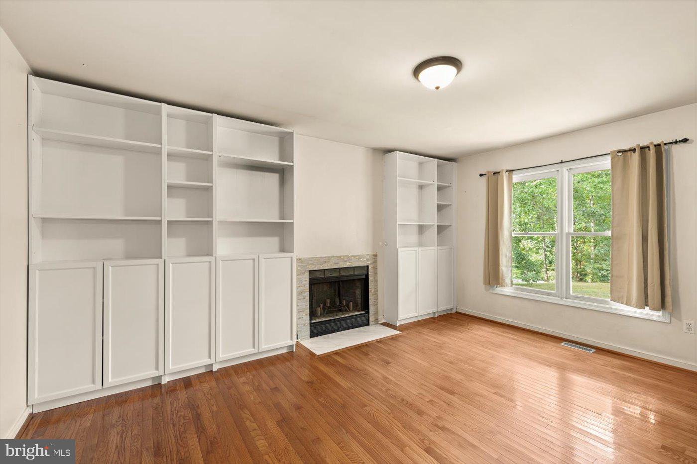 975 Swan Lane Ruther Glen, VA 22546 - Photo 9 of 42 a view of an empty room with a window and wooden floor