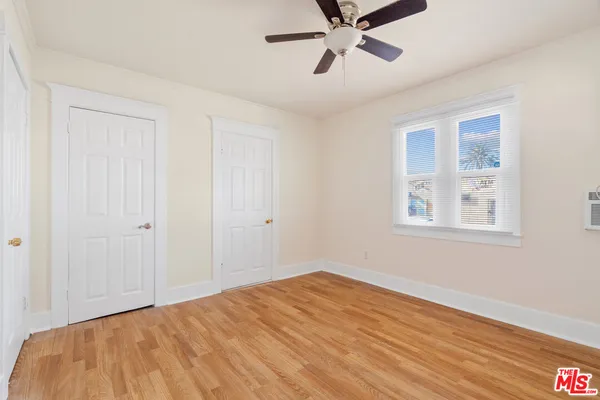 a view of a room with a window and wooden floor