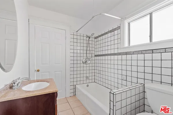 a bathroom with a sink shower and a bathtub