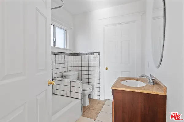 a bathroom with a sink a bathtub and shower