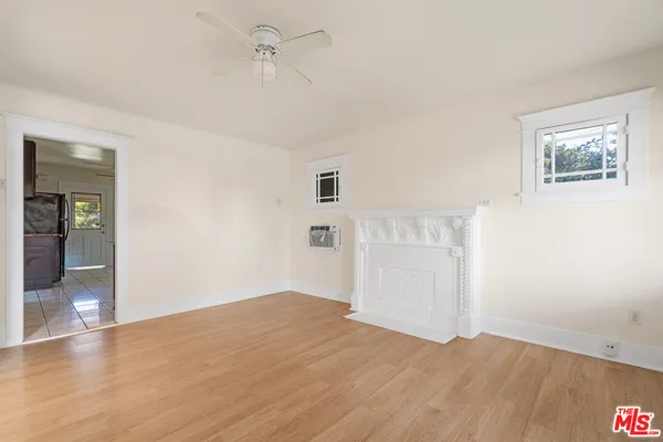 a view of empty room with wooden floor