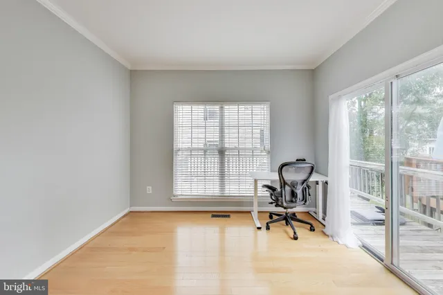 a view of a room with a table and chairs