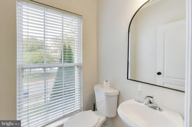 a bathroom with a sink a mirror and a toilet
