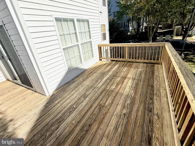 a view of balcony with wooden floor and fence
