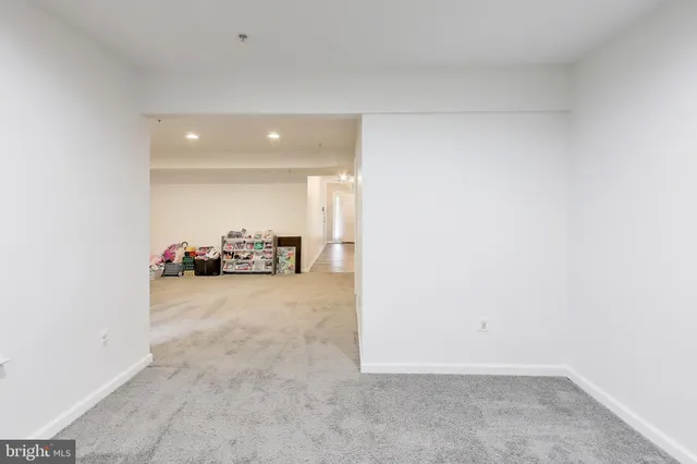 a view of a room with a large mirror and a sink