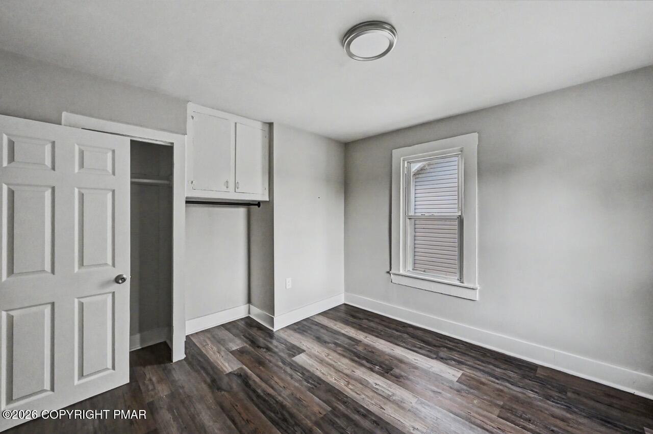 432 Edwards Court Scranton, PA 18504 - Photo 23 of 34 an empty room with wooden floor and windows