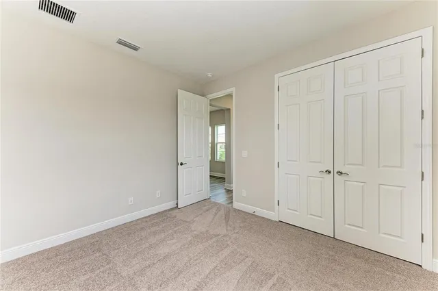 a view of an empty room and closet area