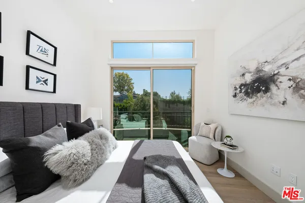 a bedroom with a bed and a lamp