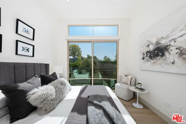 a bedroom with a bed and a lamp