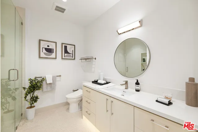 a bedroom with a bed and a lamp