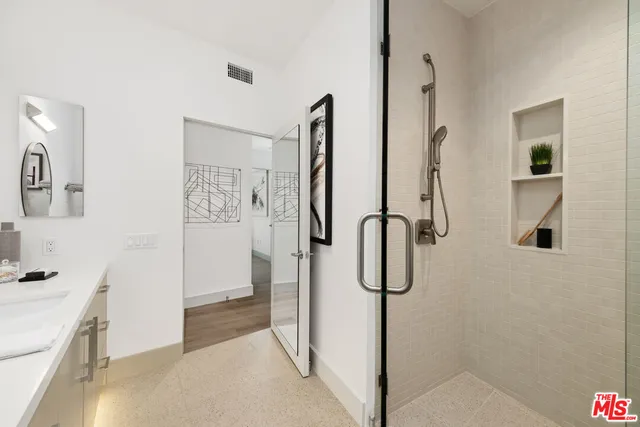 a bedroom with a bed and a potted plant