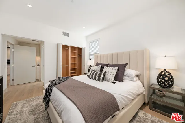 a kitchen with stainless steel appliances kitchen island granite countertop a refrigerator and a stove top oven