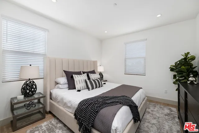 a kitchen with granite countertop white cabinets and stainless steel appliances