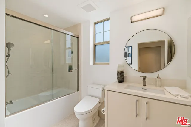 a kitchen with stainless steel appliances a sink stove and cabinets