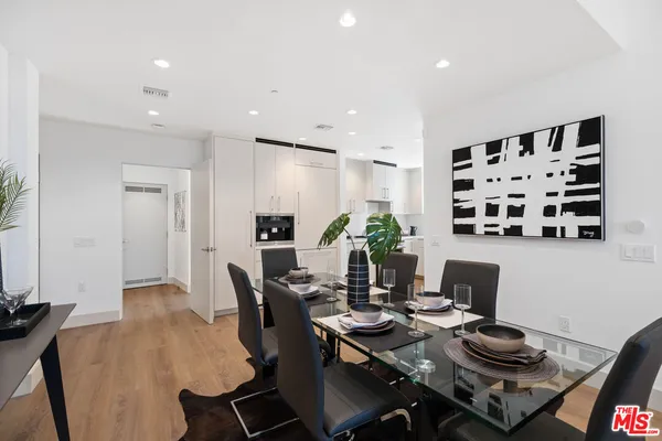 a living room with furniture a rug and a floor to ceiling window
