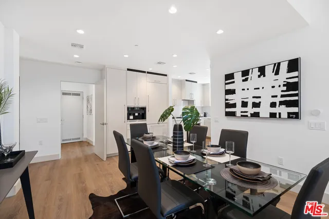 a living room with furniture a rug and a floor to ceiling window