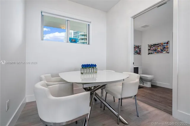 a spacious bedroom with a bed and a chandelier