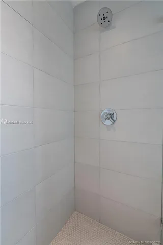 a bedroom with bed and a window