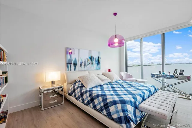 a bedroom with a bed and glass window