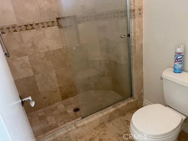 a bathroom with a shower and a toilet