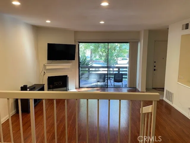 a living room with a fireplace and a flat screen tv