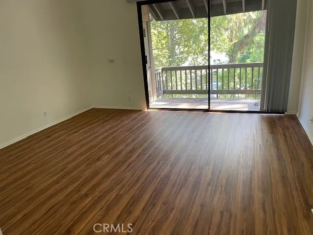 a view of wooden floor and brick walls