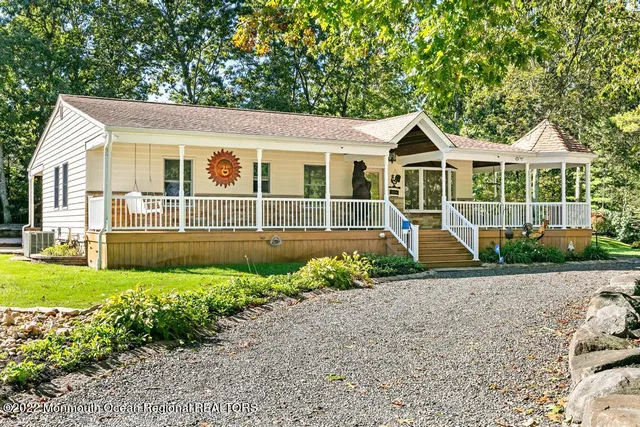 a front view of a house with a yard and potted plants