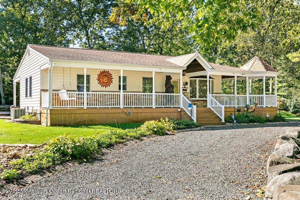a front view of a house with a yard and potted plants