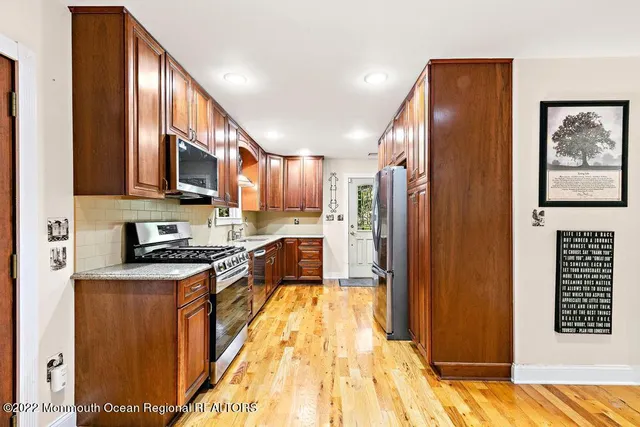 a kitchen with stainless steel appliances a stove a sink and a microwave