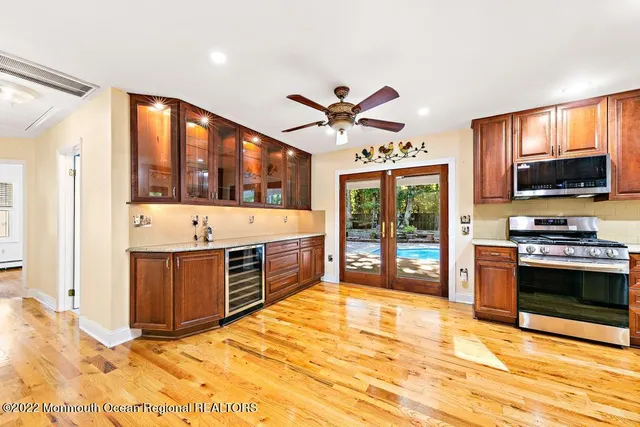 a view of a kitchen with granite countertop a fireplace and a sink
