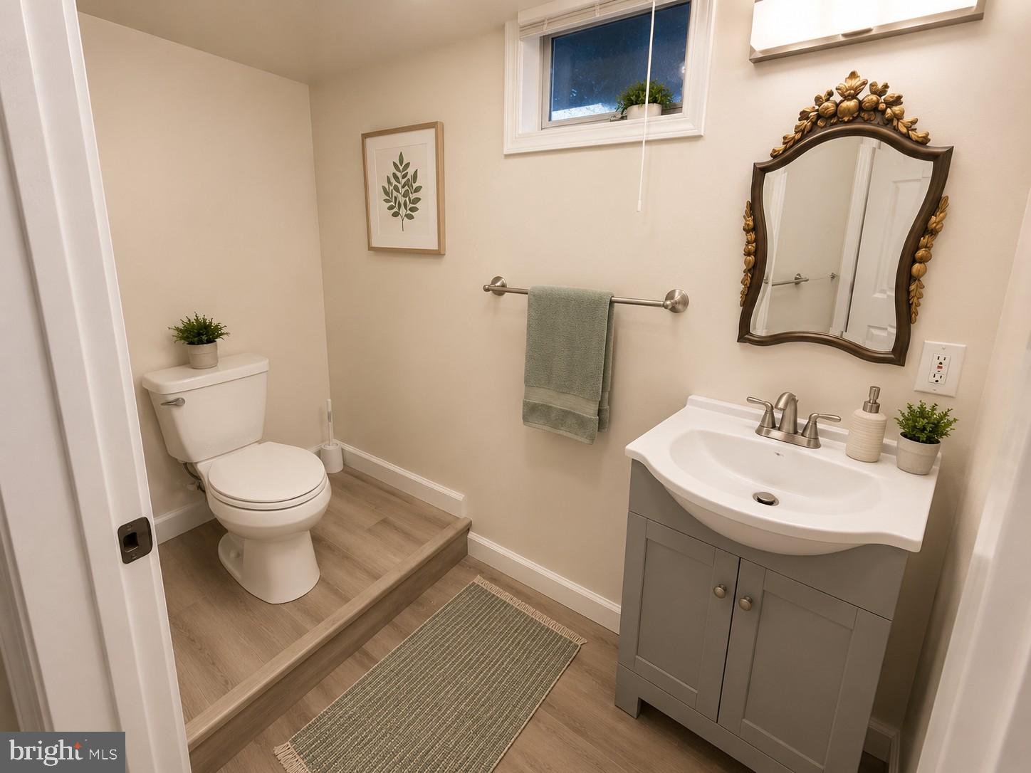 12658 Scaggsville Road Highland, MD 20777 - Photo 10 of 13 a bathroom with a toilet sink and mirror