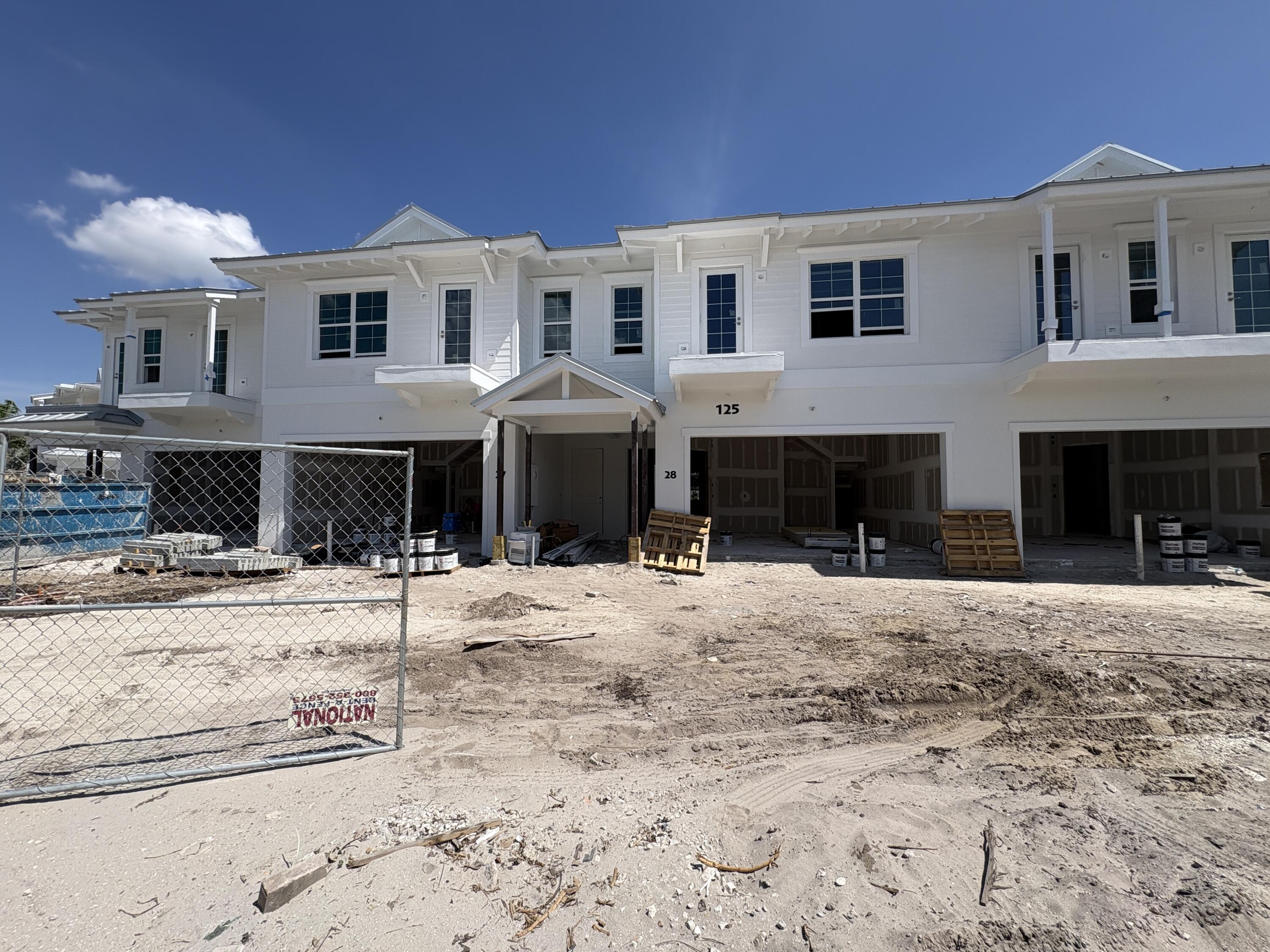 125 Water Pointe Place, Unit 28 Jupiter, FL 33477 - Photo 4 of 19 a front view of a house with a yard and trees in the background