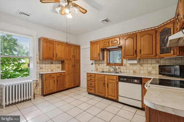 a kitchen with stainless steel appliances granite countertop a sink and cabinets