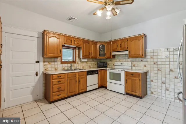 a kitchen with stainless steel appliances granite countertop a sink and cabinets