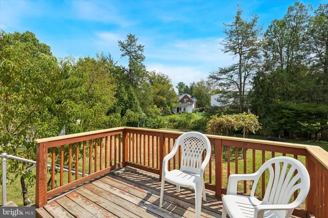 a view of a wooden deck with furniture