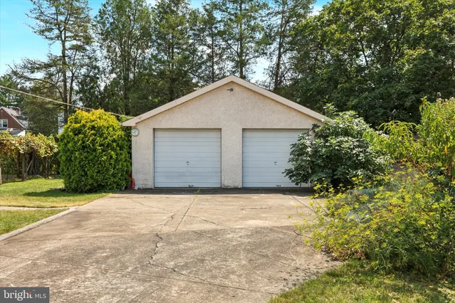 a view of a house with a yard and garage