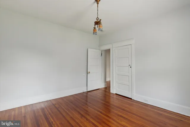a view of a room with wooden floor and ceiling fan