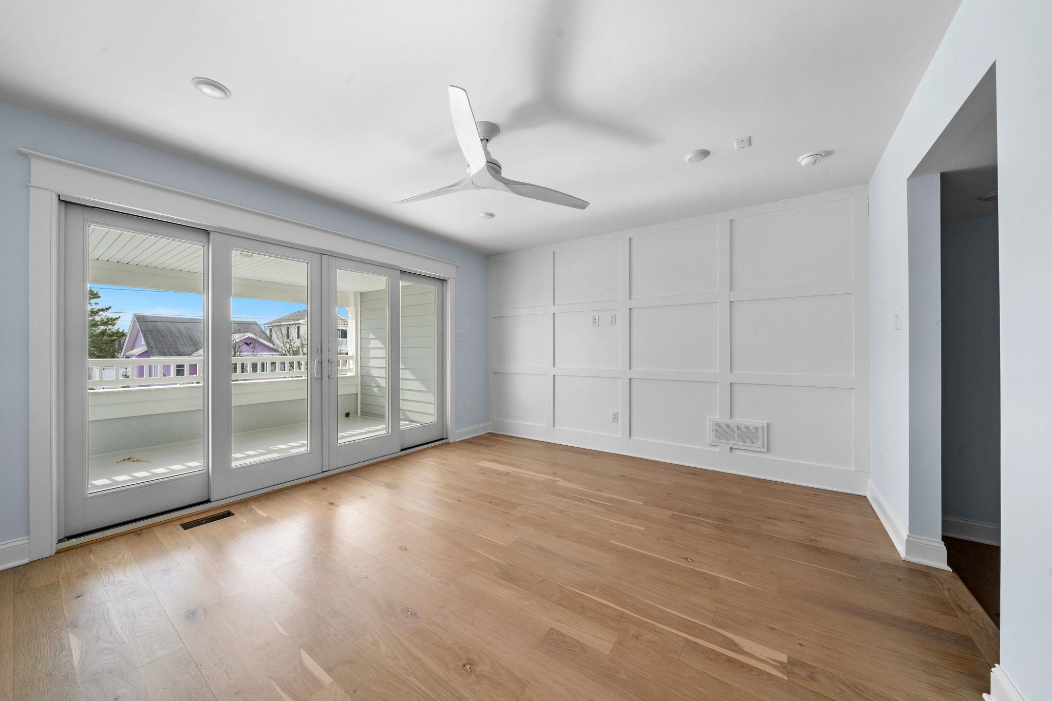 249 35th Street, Unit EAST SIDE Avalon, NJ 08202 - Photo 17 of 45 a view of an empty room with glass door and a window