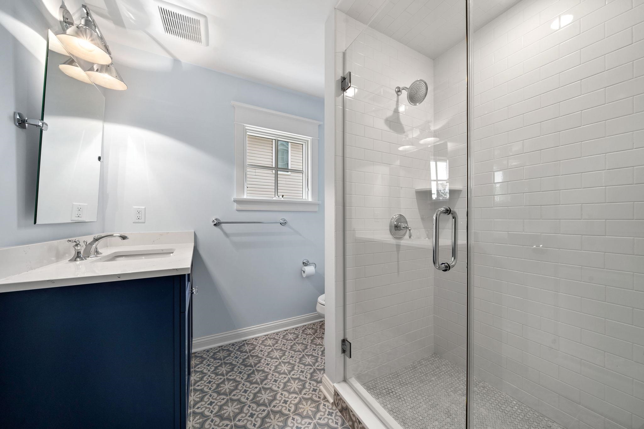 249 35th Street, Unit EAST SIDE Avalon, NJ 08202 - Photo 18 of 45 a bathroom with a sink a toilet and shower