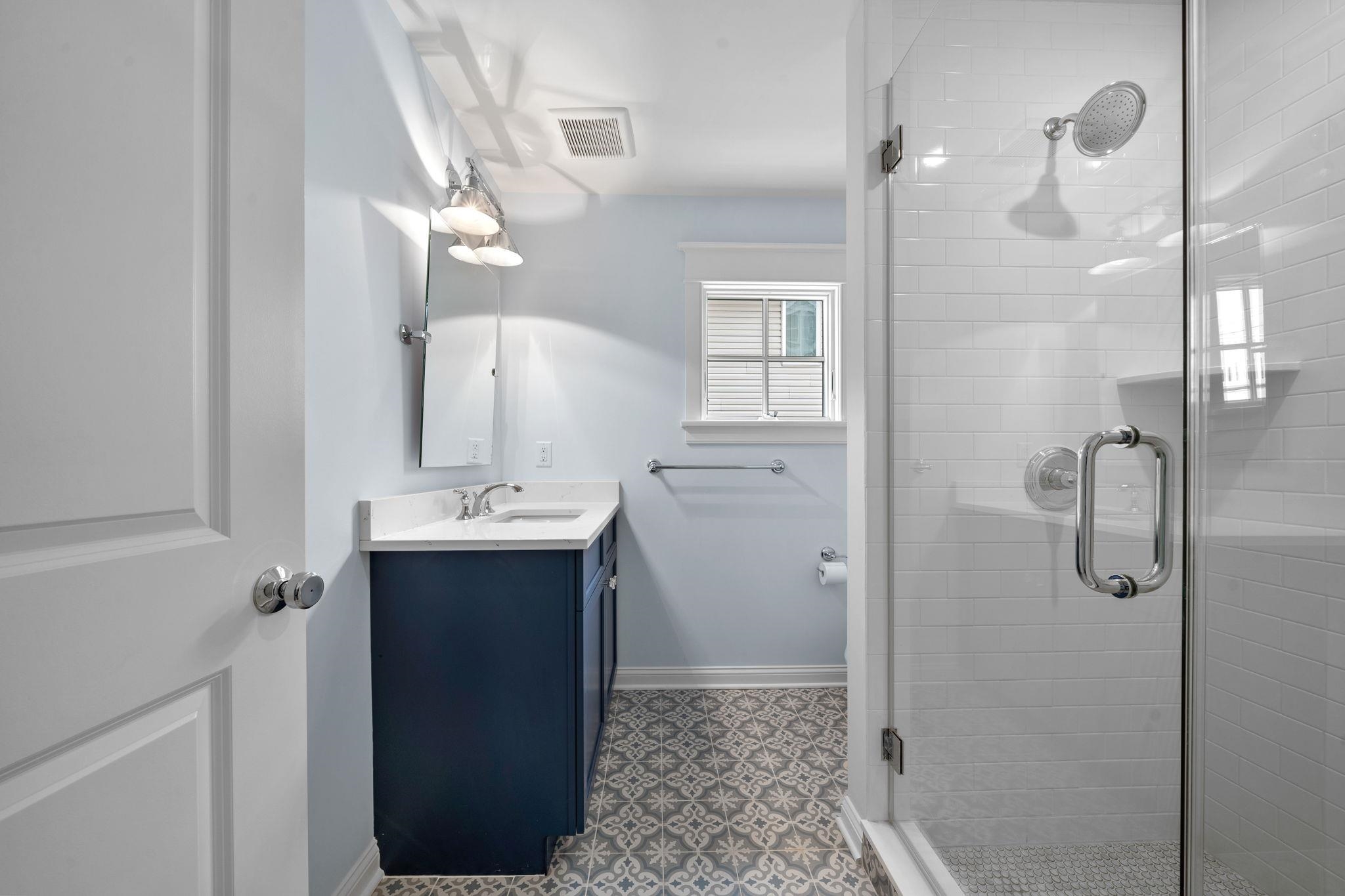249 35th Street, Unit EAST SIDE Avalon, NJ 08202 - Photo 19 of 45 a bathroom with a sink a mirror and shower