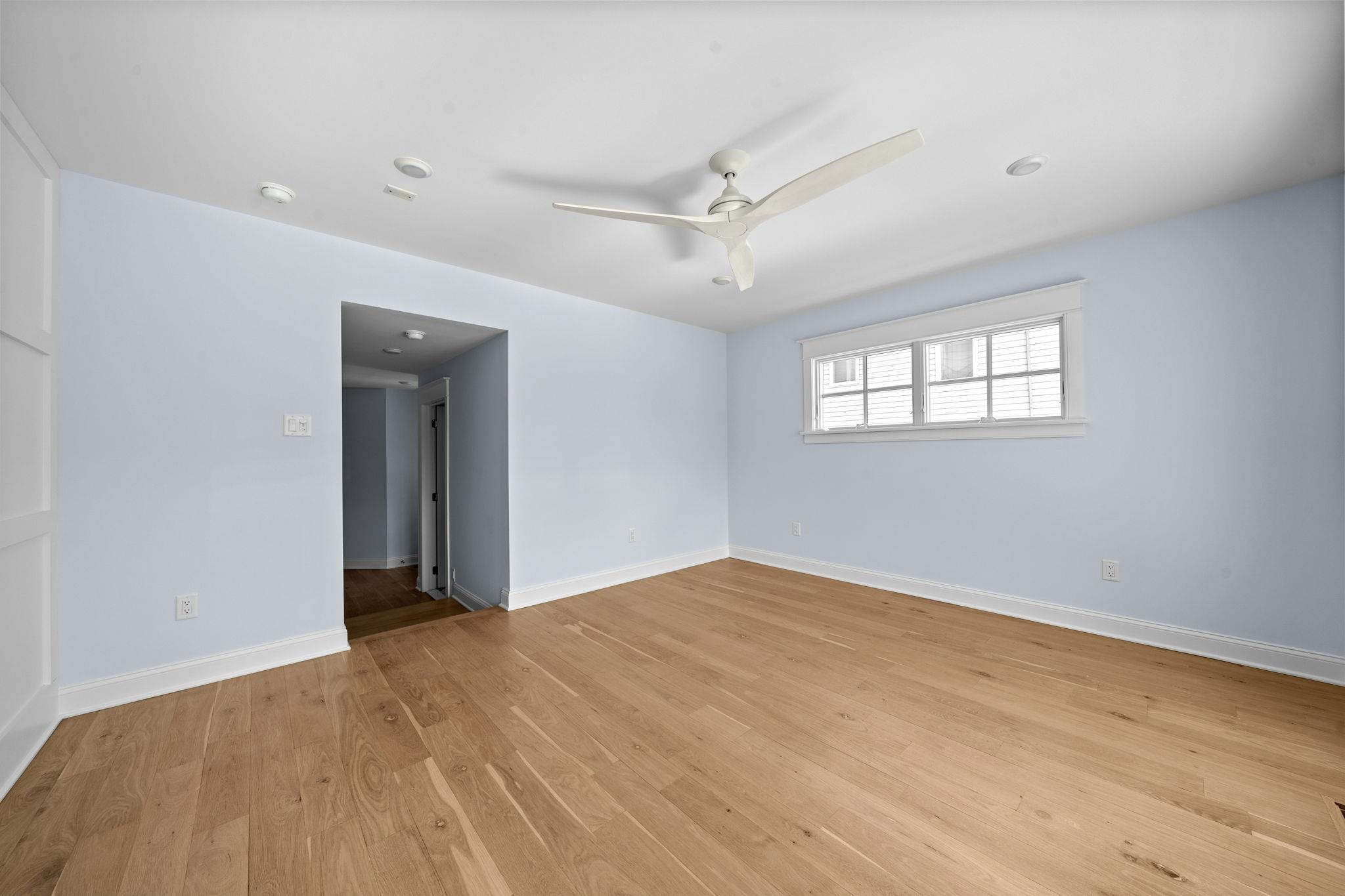 249 35th Street, Unit EAST SIDE Avalon, NJ 08202 - Photo 21 of 45 wooden floor in an empty room with a window