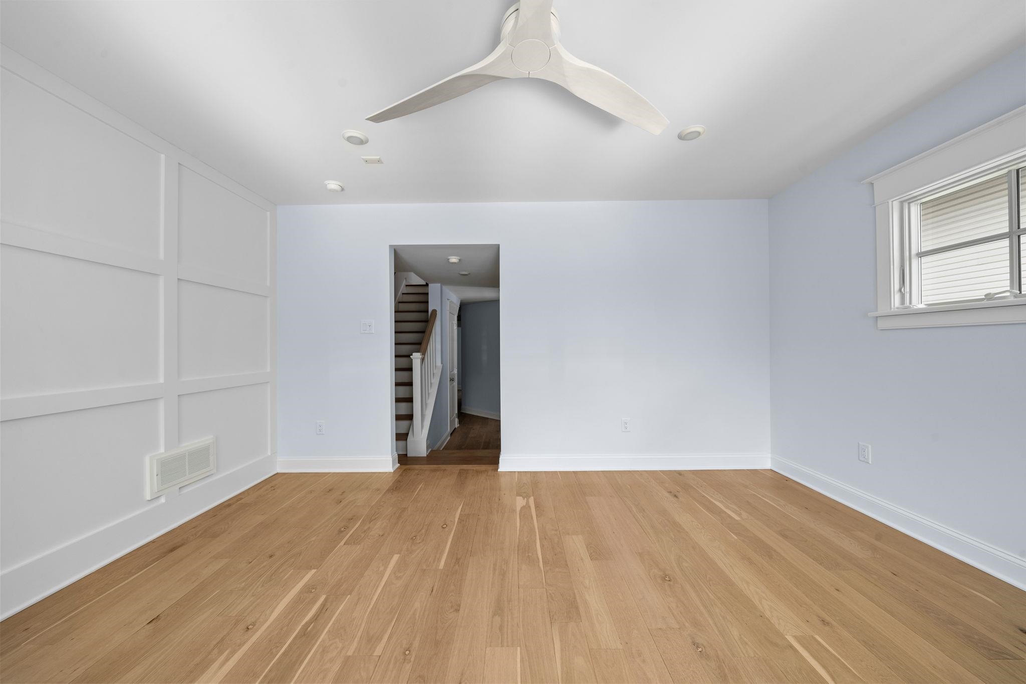 249 35th Street, Unit EAST SIDE Avalon, NJ 08202 - Photo 22 of 45 a view of an empty room with wooden floor and a window