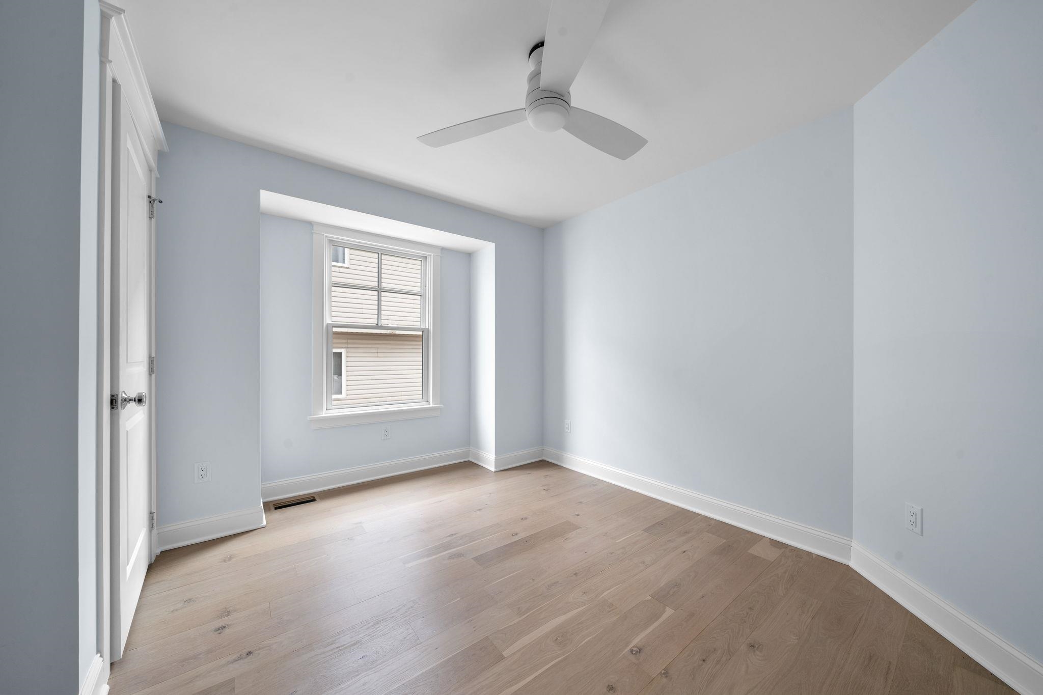 249 35th Street, Unit EAST SIDE Avalon, NJ 08202 - Photo 25 of 45 an empty room with wooden floor and windows