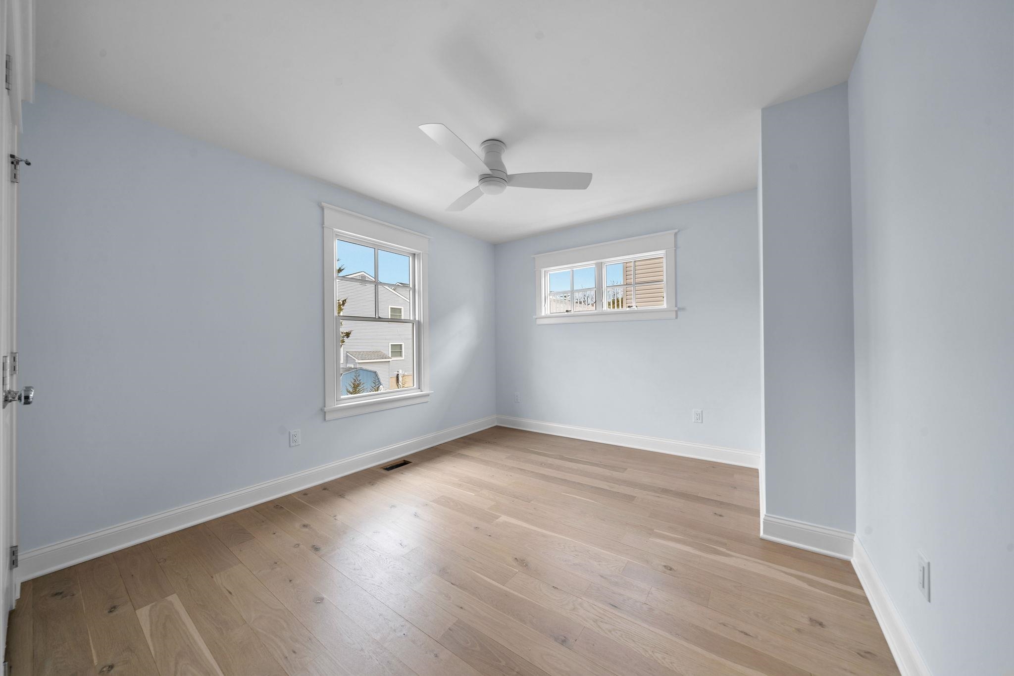 249 35th Street, Unit EAST SIDE Avalon, NJ 08202 - Photo 28 of 45 wooden floor in an empty room with a window